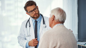 Shot of a doctor examining a senior patient in a clinic