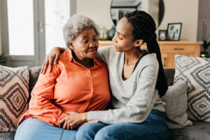 A woman hugs her mom as she considers whether it’s time for 24-hour care for dementia.