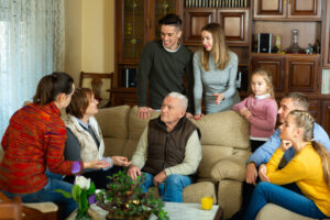 People sit together with an older loved one, resolving caregiving conflict in blended families.