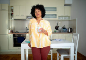 A woman who knows the importance of placing limits on your caregiving responsibilities enjoys a coffee break.