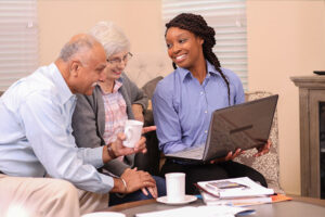 An older couple review their care plan with their care professional.