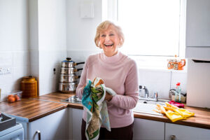 A woman smiles as she experiences the benefits of boosted independence for someone with dementia.